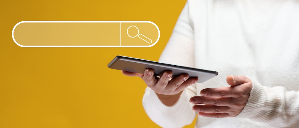 a person holding a tablet looking through the internet